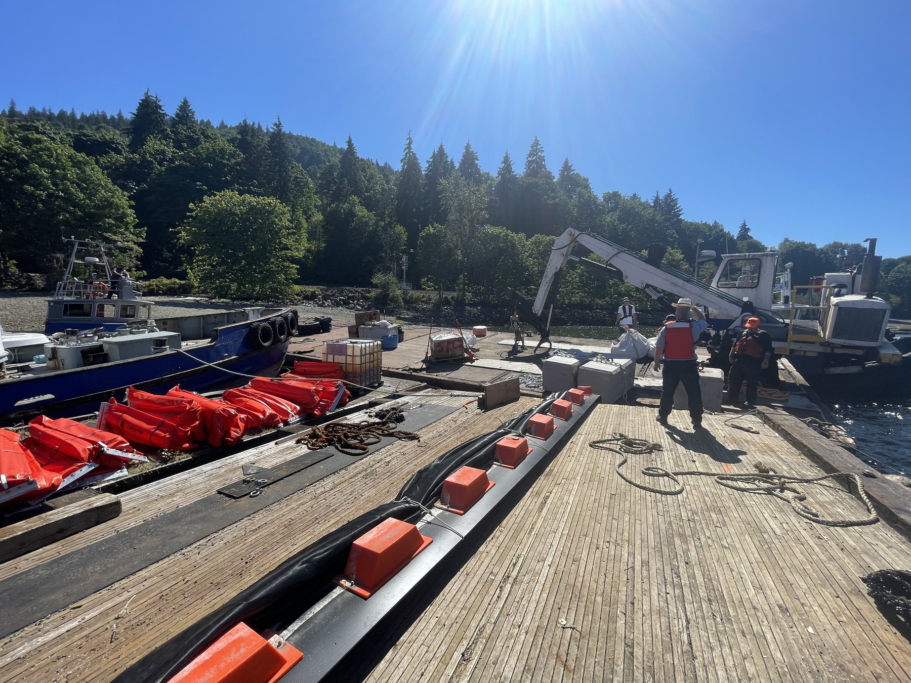 Crew staging containment boom on dock for deployment