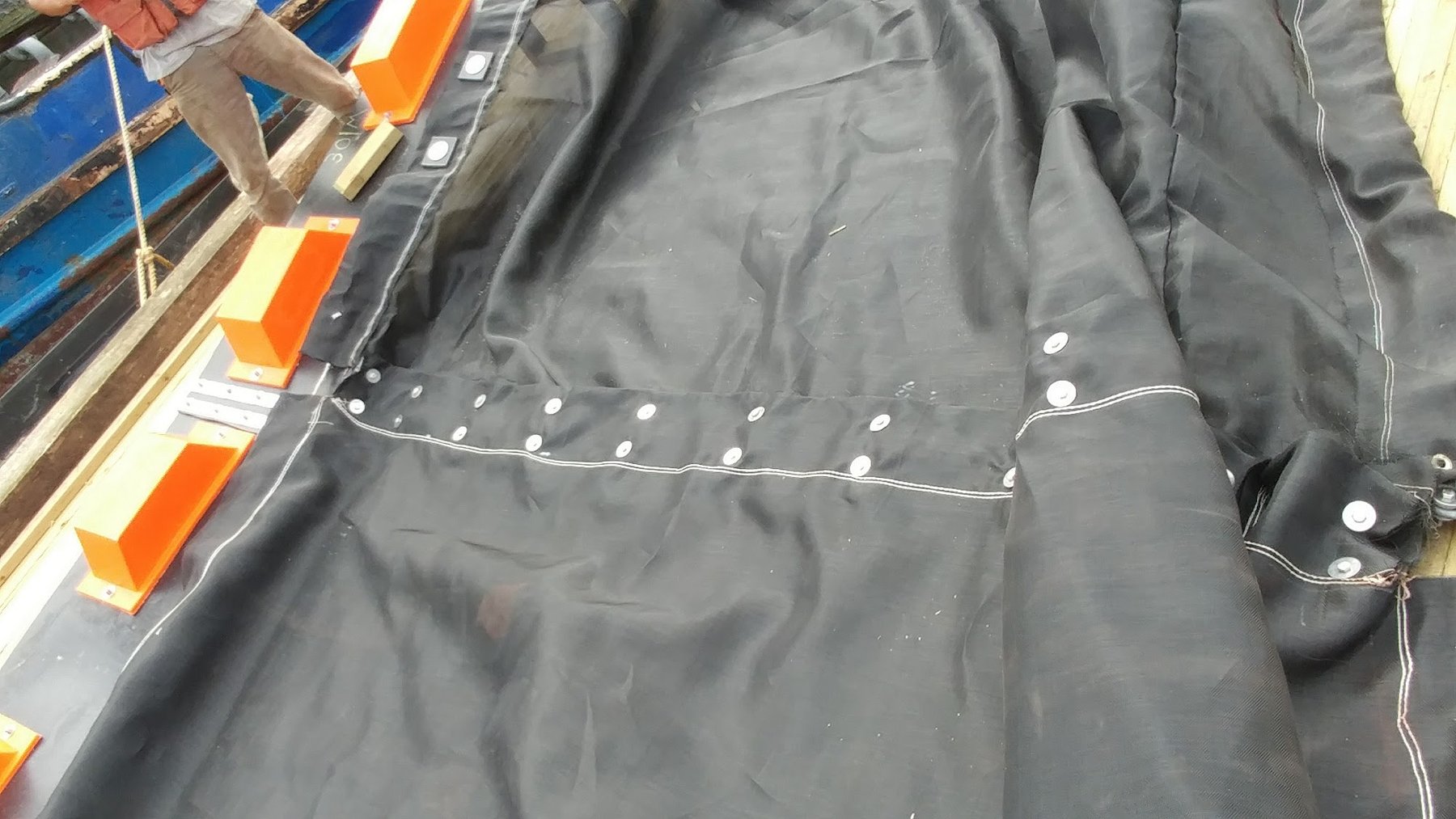 Impermeable silt curtain laid out showing ballast line attachment points
