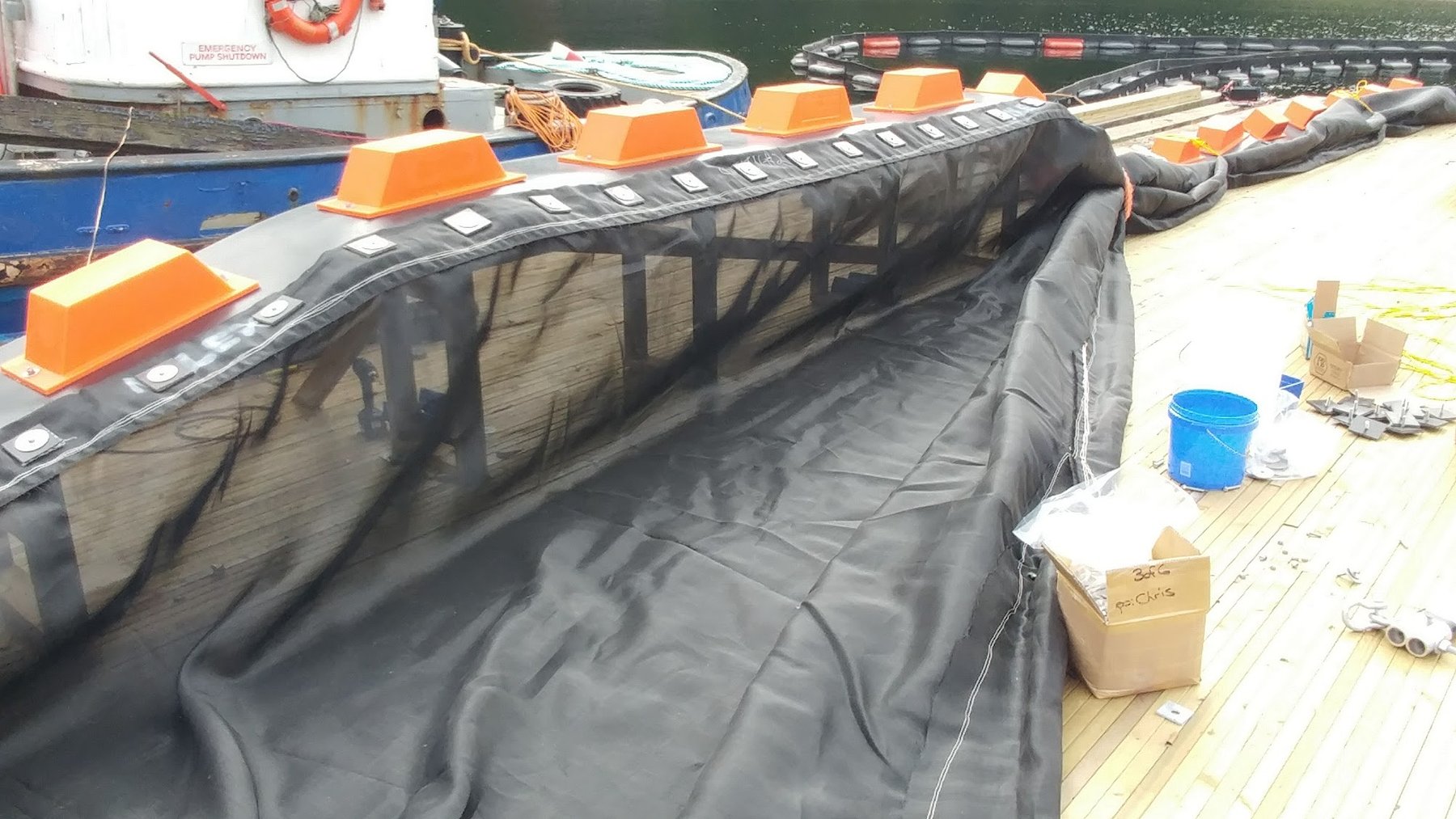 Silt curtain skirt deployed on dock showing sediment barrier depth