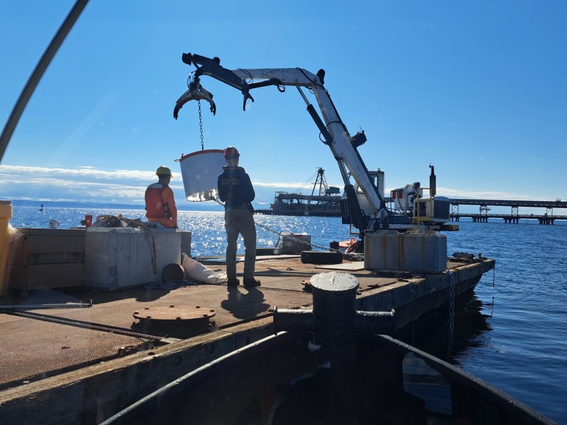 Anchor block handled by crane for construction boom mooring installation