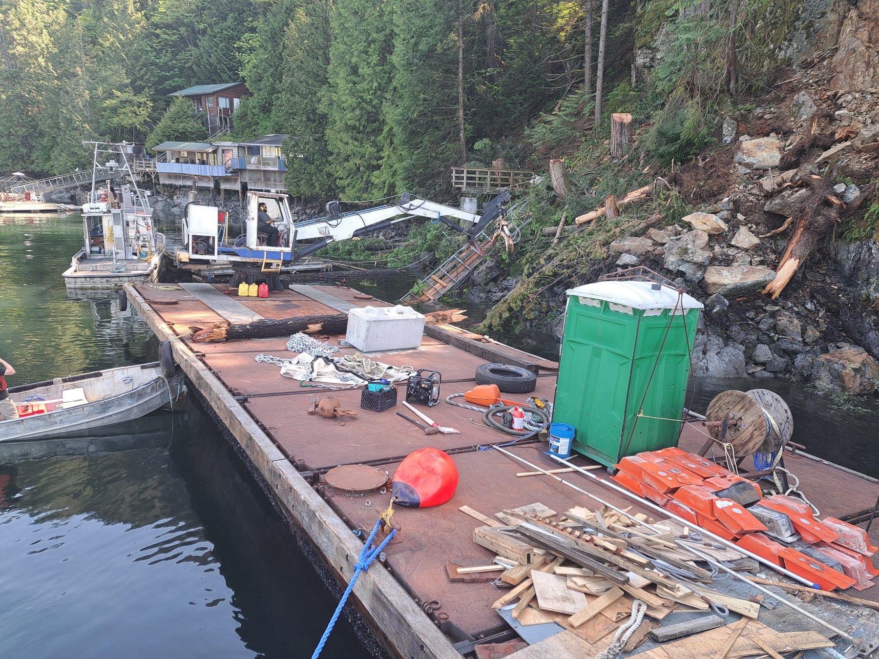 Work barge loaded with collected marine debris during shoreline cleanup