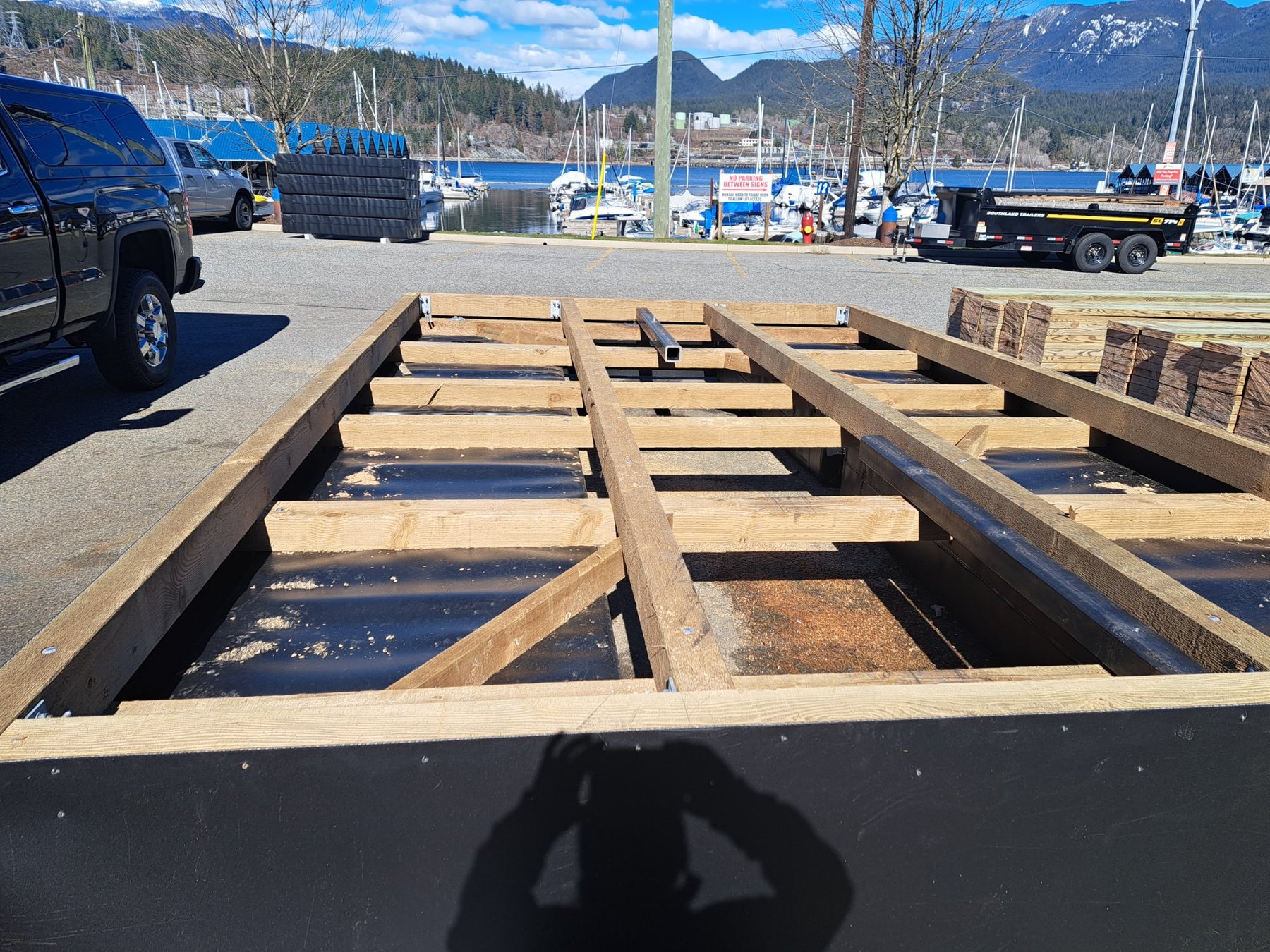 Timber joist framing on HDPE pontoon float during dock build