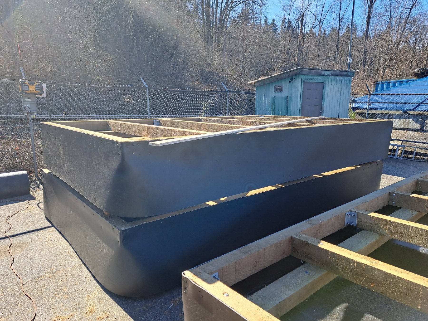 Completed HDPE pontoon floats staged at yard for dock assembly