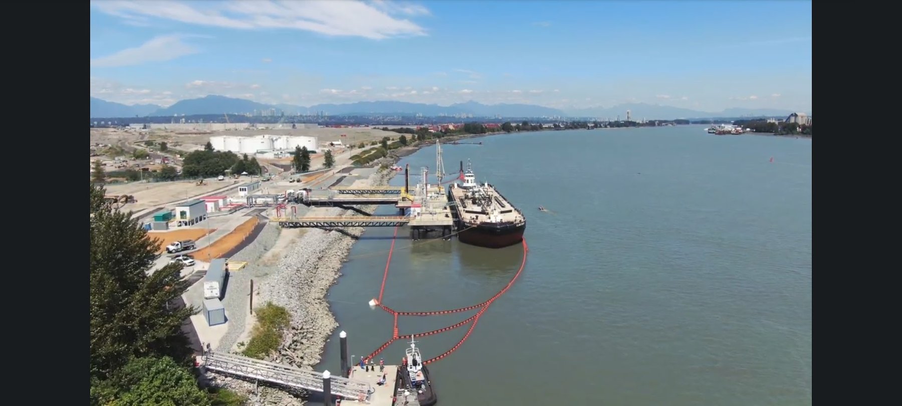 Aerial view of tanker with deployed containment boom at Fraser River fuel terminal